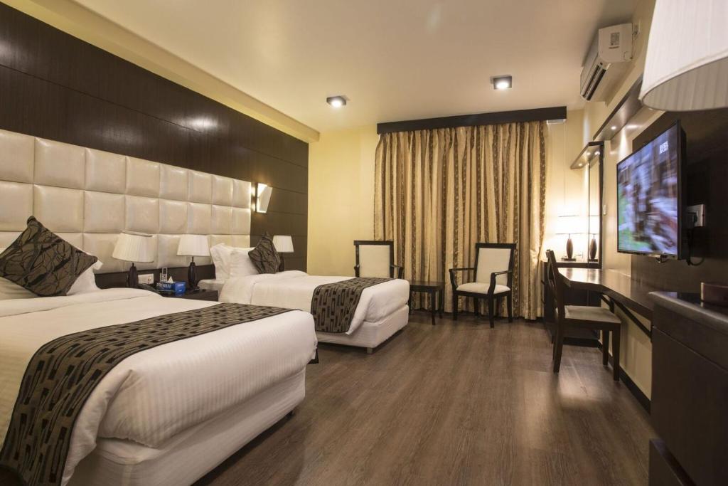 Postel nebo postele na pokoji v ubytování United Business Hotel