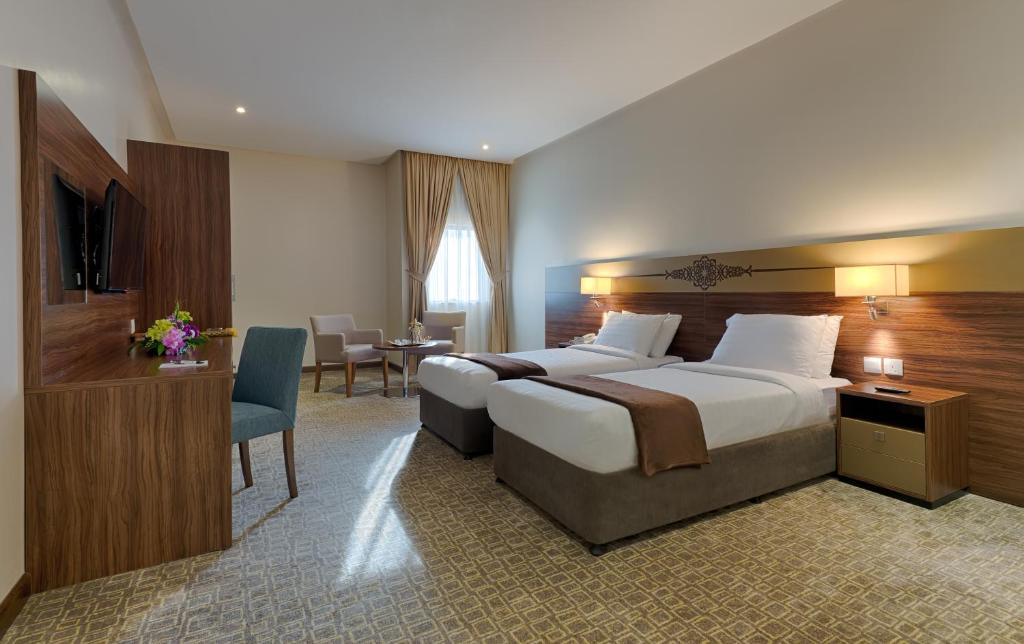 Postel nebo postele na pokoji v ubytování Snaf Inn ِAzizia Hotel