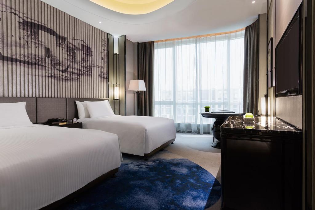 Tempat tidur dalam kamar di Wanda Realm Hotel Wuhu