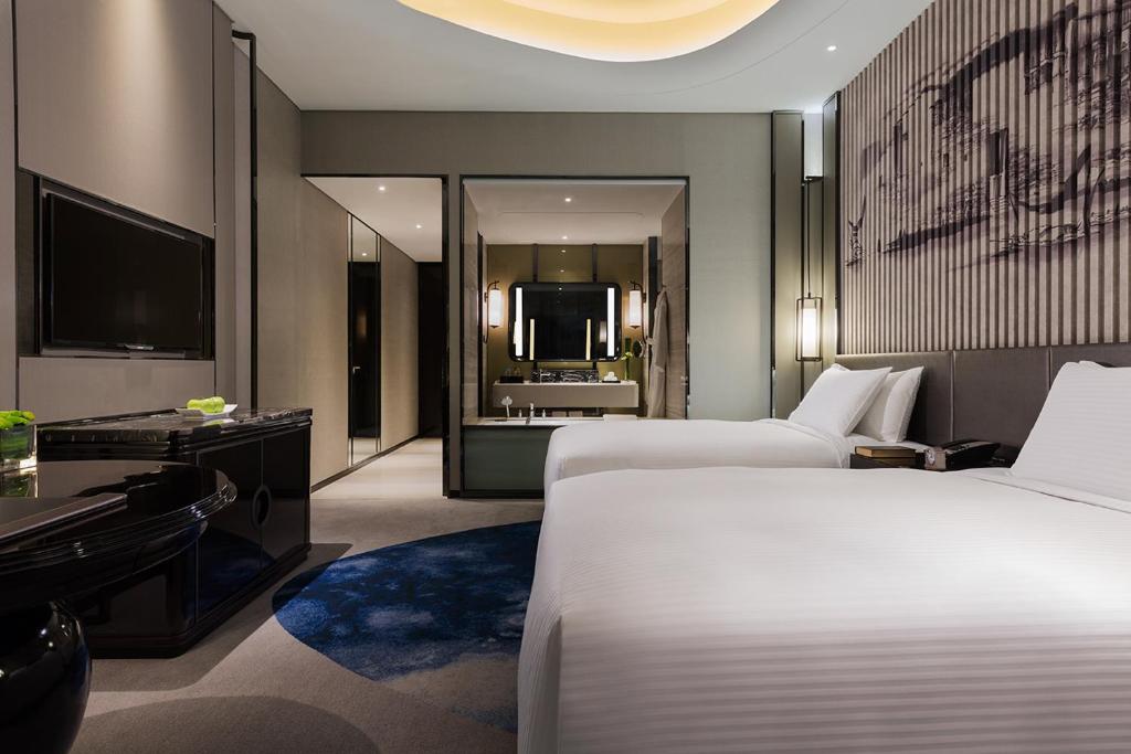 Postel nebo postele na pokoji v ubytování Wanda Realm Hotel Wuhu