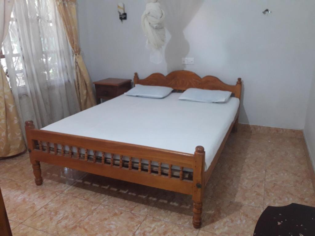 Postel nebo postele na pokoji v ubytování New Land Guest House