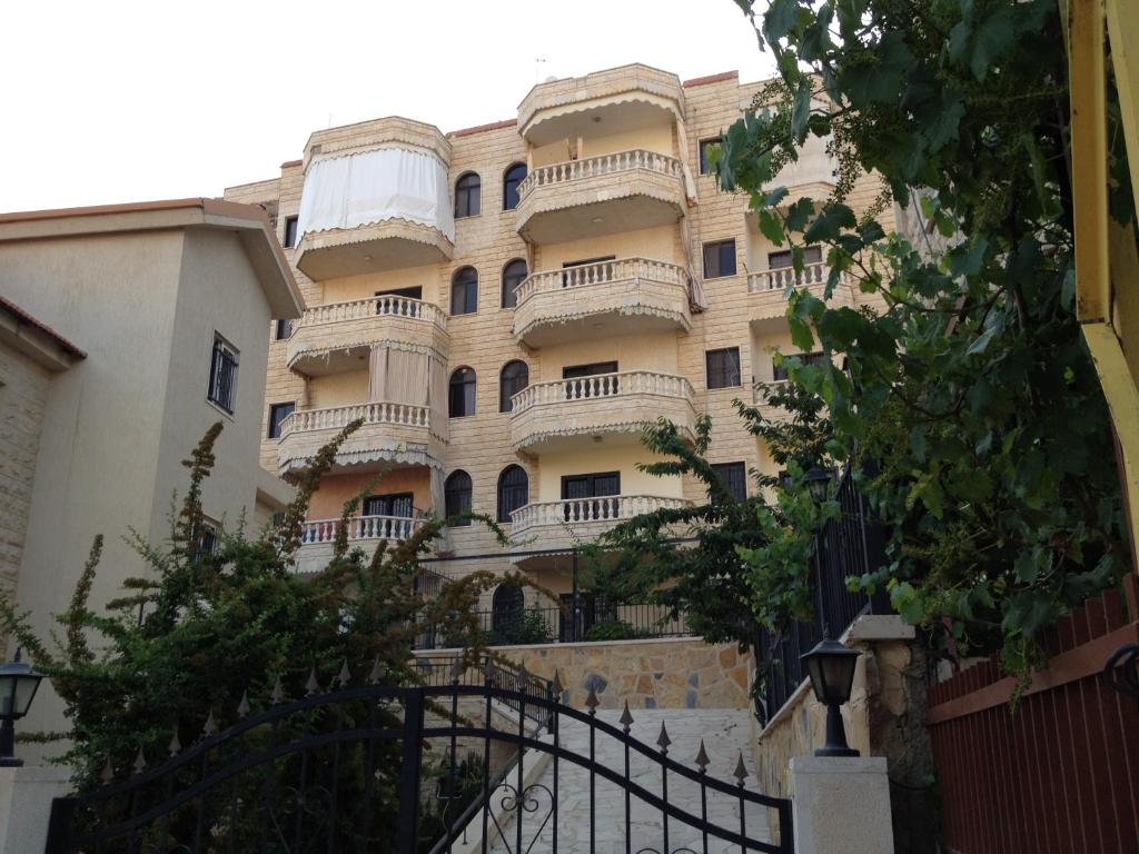 a building with balconies on the side of it at Wonderful Apartment in Rujūm