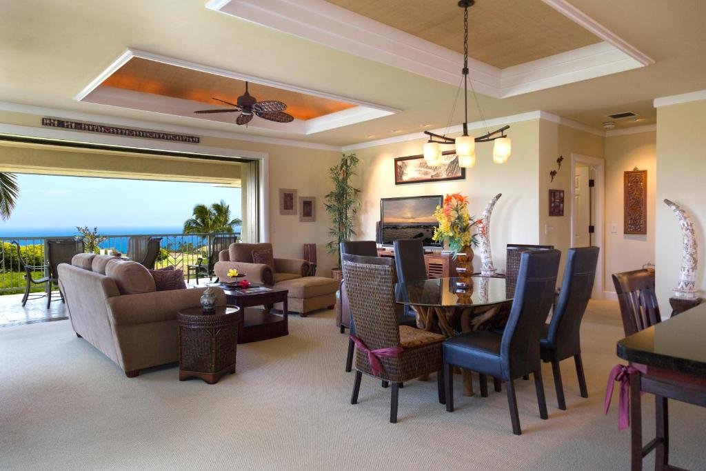 a living room with a table and chairs and a couch at Wai'ula'ula D201 in Hapuna Beach