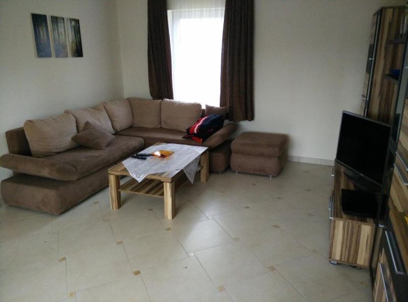 a living room with a couch and a coffee table at Gemutlicher Ferienbungalow am Felsensee bei Pretzien in Pretzien