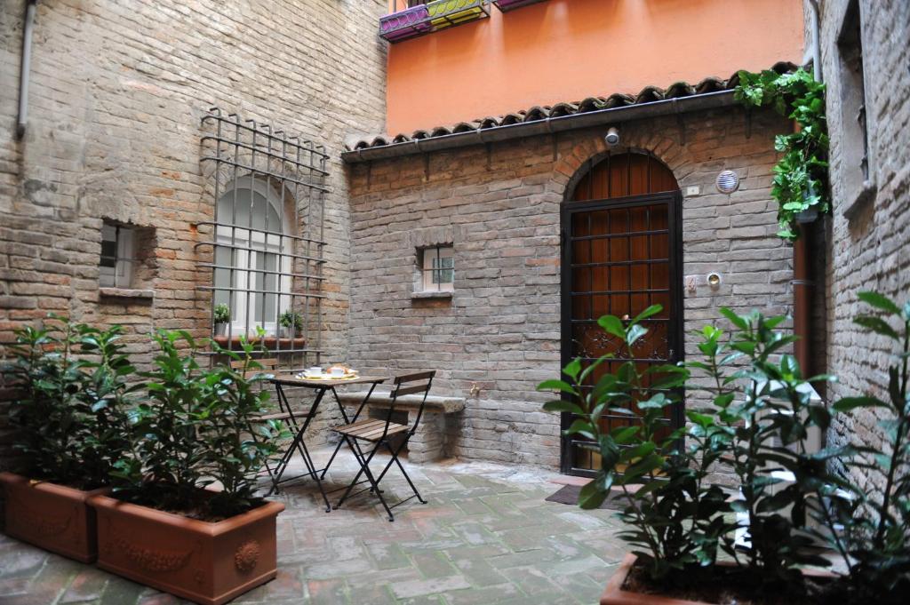 an outdoor patio with a table and chairs at Oberdan Apartment in Bologna