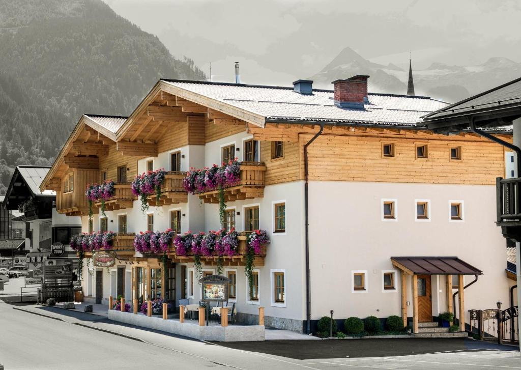 a large building with many windows on top of it at Pension Alpenrose in Kaprun