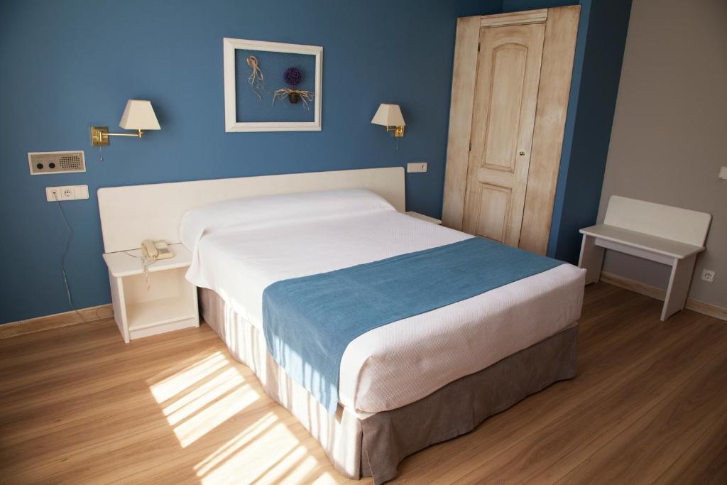 Postel nebo postele na pokoji v ubytování Hotel Jakue