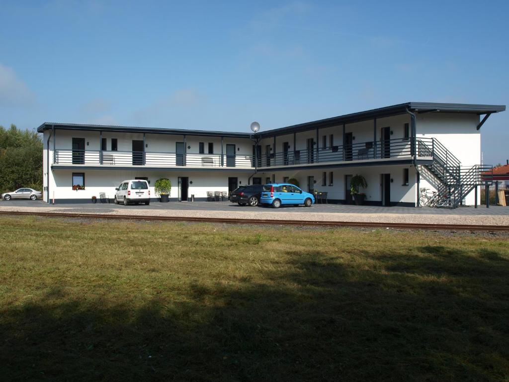 a large building with cars parked in front of it at Gästehaus Strauss in Rodgau