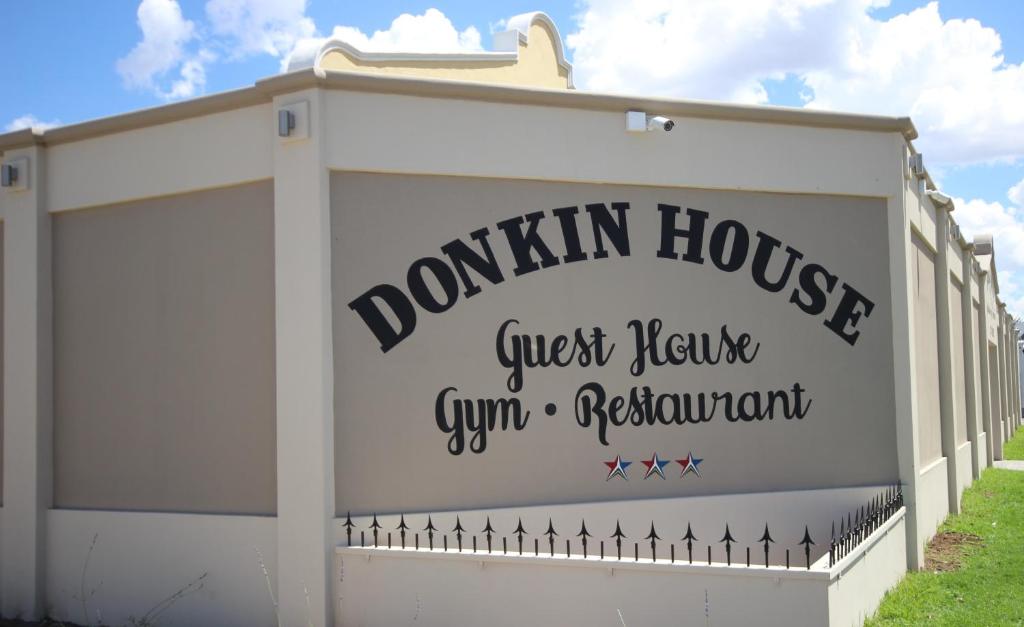 
a sign that is on the side of a building at Donkin Country House in Beaufort West
