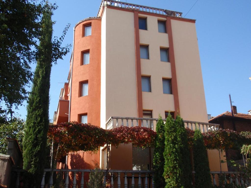 a tall building with a fence in front of it at Family Hotel Saint Iliya in Burgas City