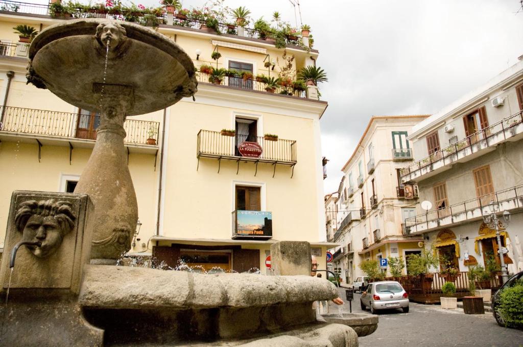 una fuente de agua frente a un edificio en B&B La Piazzetta en Paola