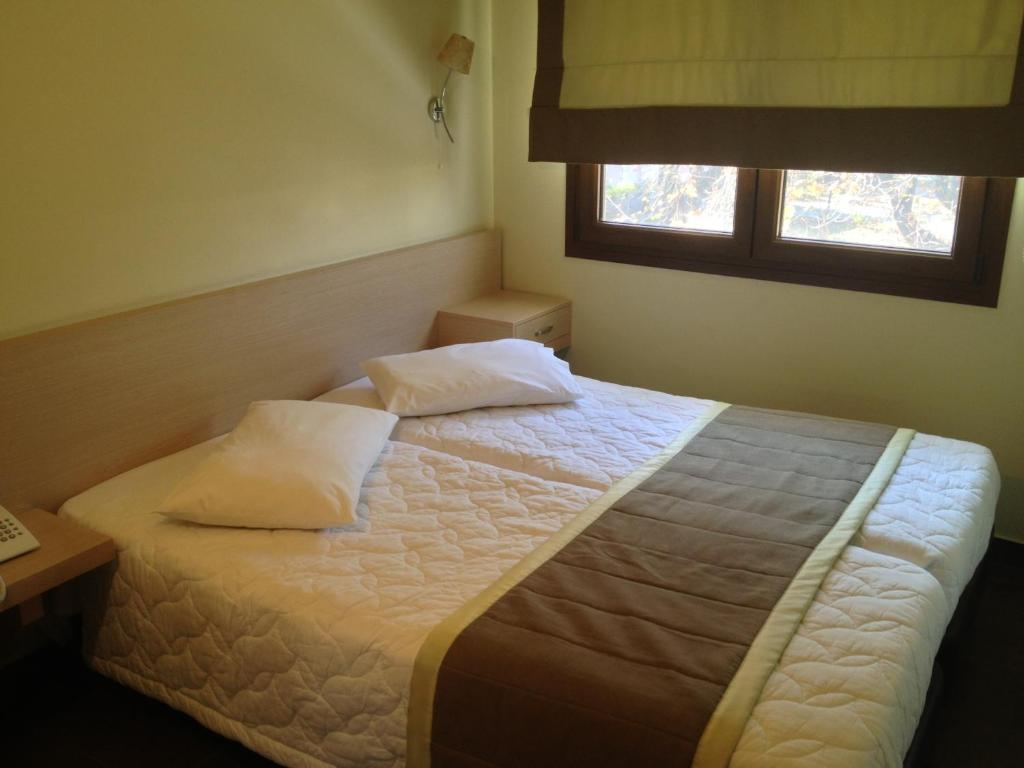 Postel nebo postele na pokoji v ubytování Hotel Ifigenia