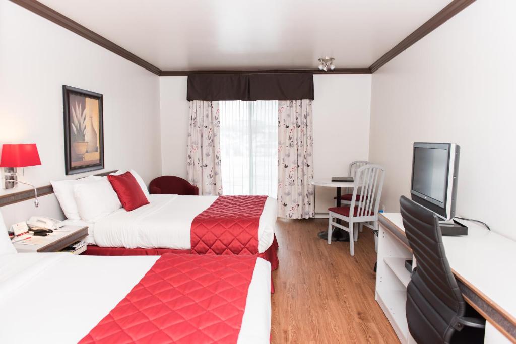 Postel nebo postele na pokoji v ubytování Hôtel Le Floral