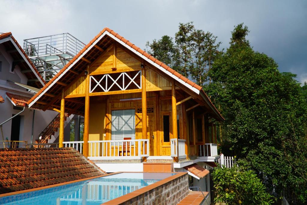 une maison avec une piscine en face de celle-ci dans l'établissement Huy Trung Homestay, à Bắc Hà
