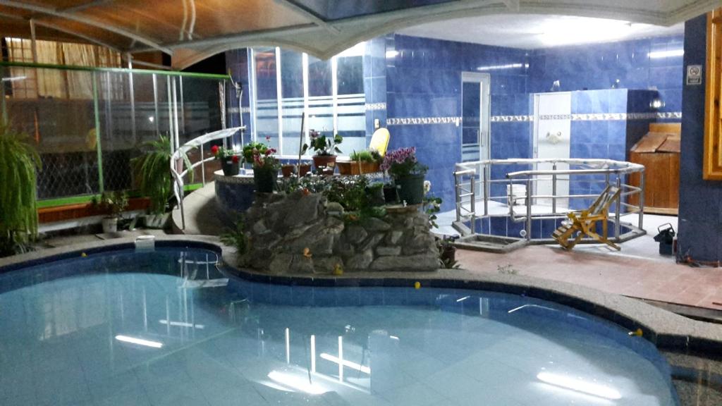 a large swimming pool in a building with at Fuentes del Volcán in Baños