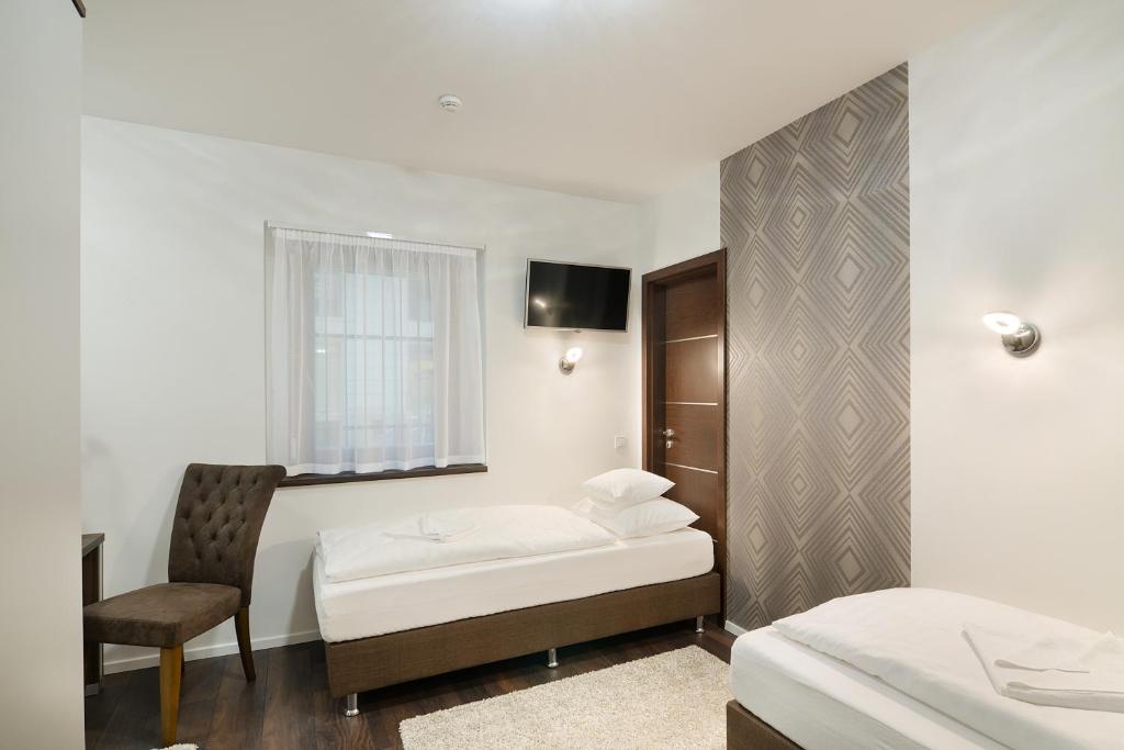 Posteľ alebo postele v izbe v ubytovaní Paulay Downtown Apartments