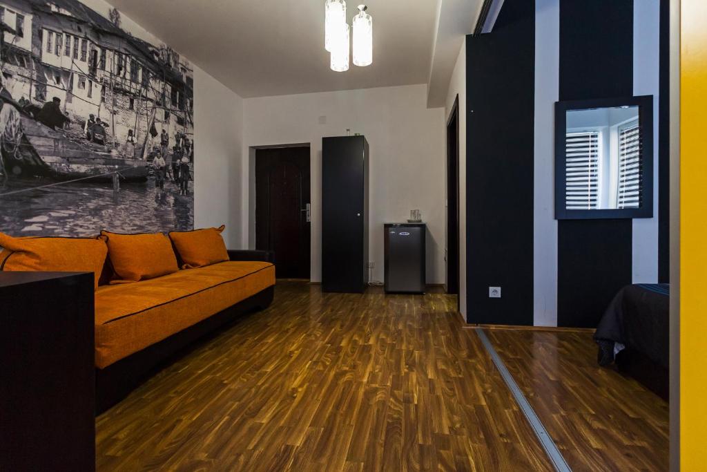 a living room with a couch and wooden floors at DJ Apartments Plus in Ohrid