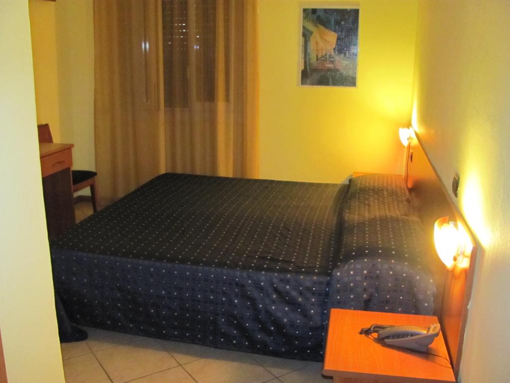 Postel nebo postele na pokoji v ubytování Albergo Hotel Giardino