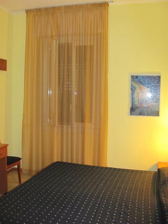 Postel nebo postele na pokoji v ubytování Albergo Hotel Giardino