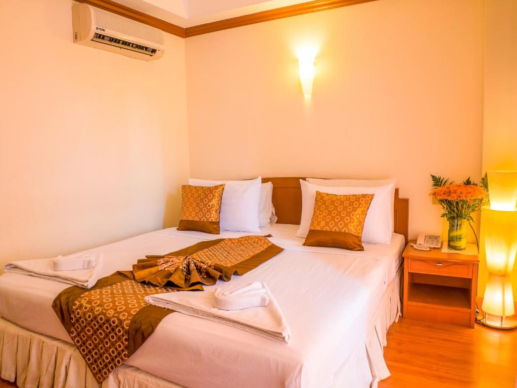 Postel nebo postele na pokoji v ubytování Chomsin Hua Hin ชมสินธุ์ หัวหิน