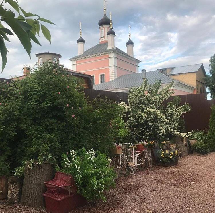 a large pink building with a bunch of plants at Hotel in Kolomna in Kolomna