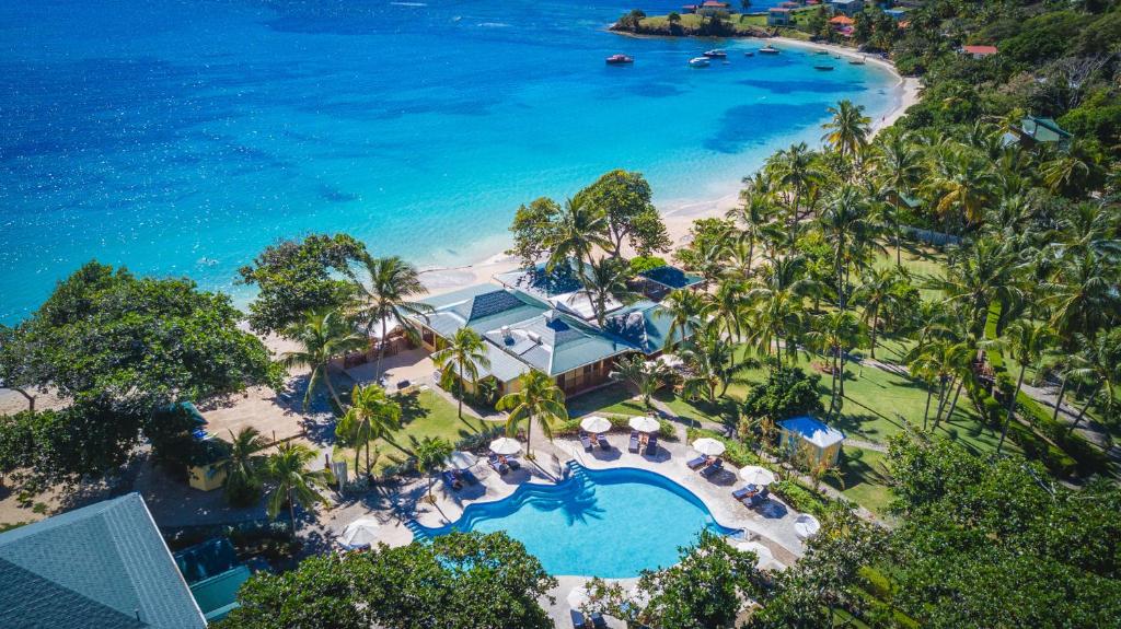 an aerial view of a resort with a pool and the beach at Bequia Beach Hotel - Luxury Resort in Friendship
