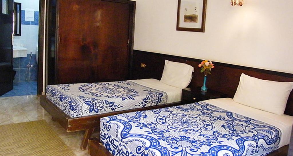 Postel nebo postele na pokoji v ubytování El Nakhil Hotel