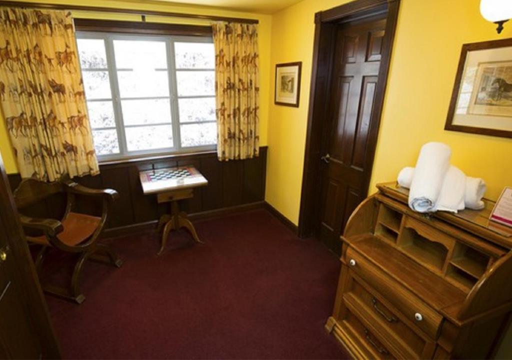 a room with a desk and a window and a chair at Madonna Inn in San Luis Obispo