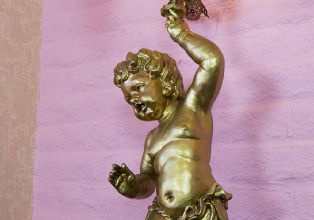 a bronze statue of a woman with her arm in the air at Madonna Inn in San Luis Obispo