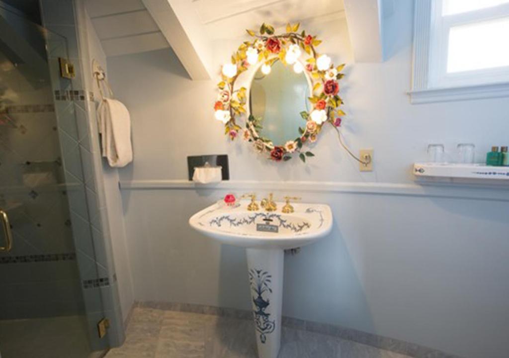 a bathroom with a sink and a mirror on the wall at Madonna Inn in San Luis Obispo
