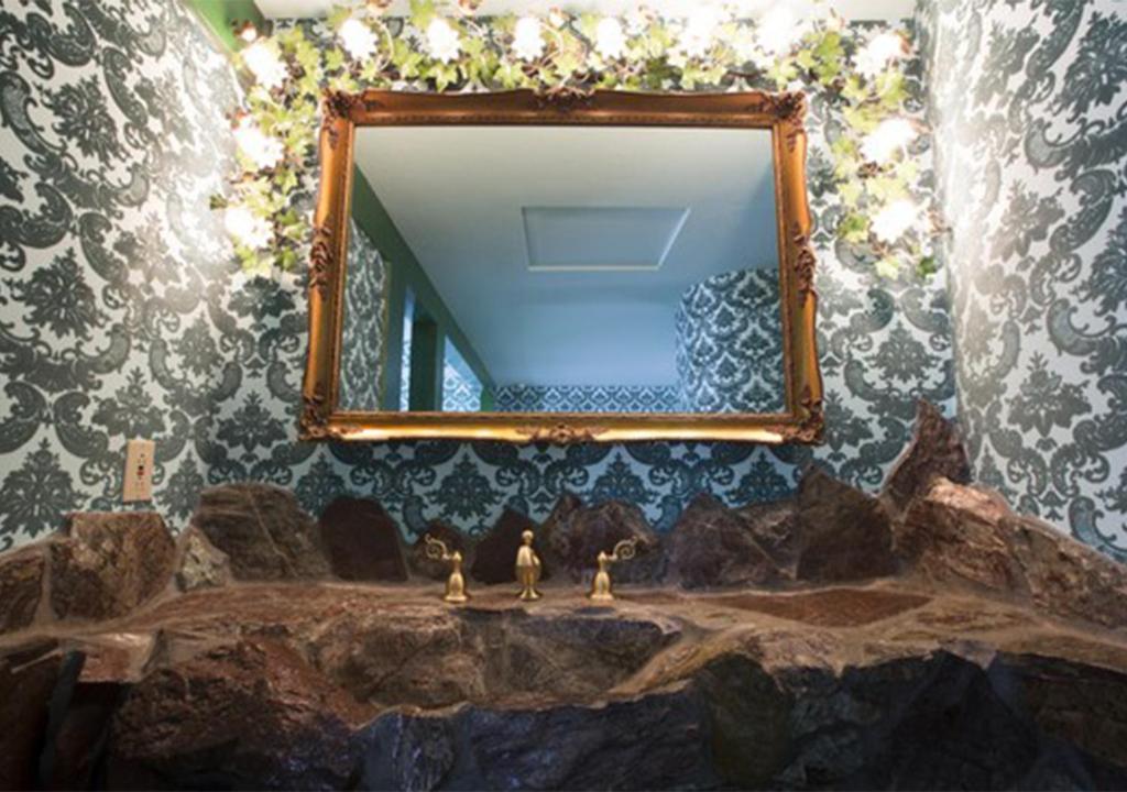 a bathroom with a mirror over a sink at Madonna Inn in San Luis Obispo