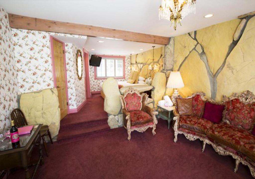 a living room with a couch chairs and a table at Madonna Inn in San Luis Obispo