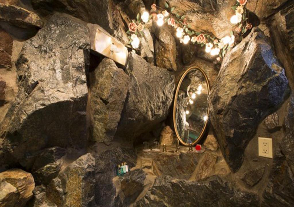 a bathroom with a mirror and some rocks at Madonna Inn in San Luis Obispo