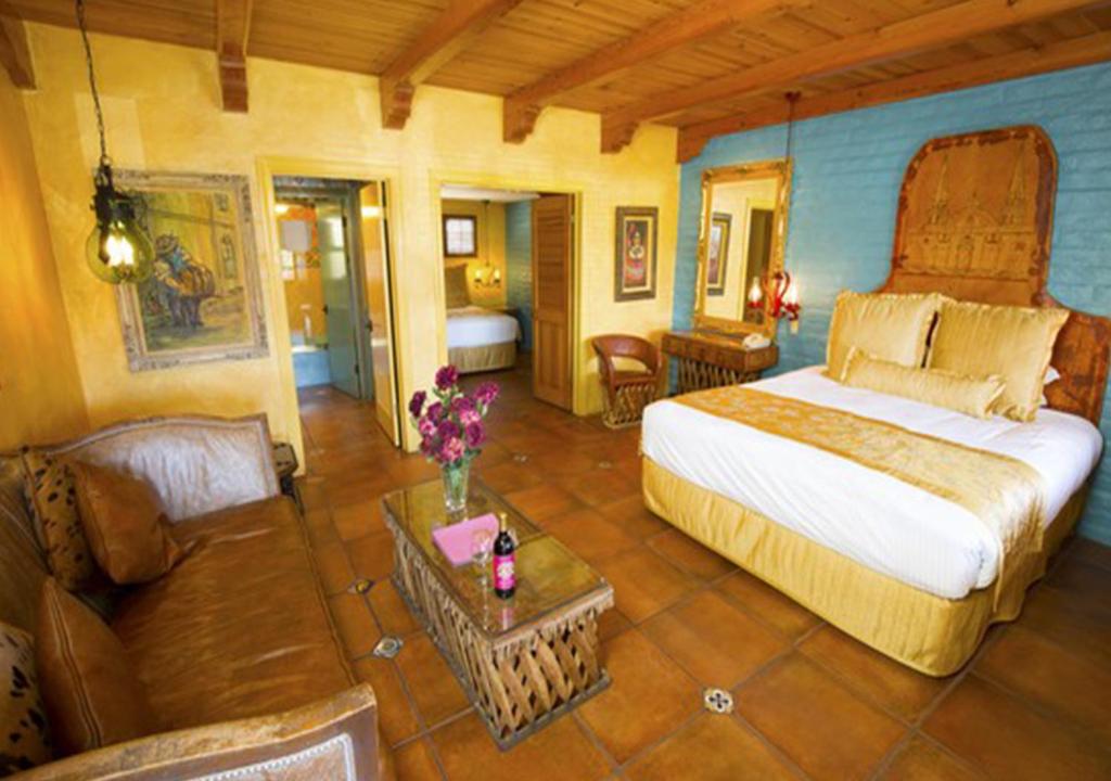 a bedroom with a large bed and a couch at Madonna Inn in San Luis Obispo