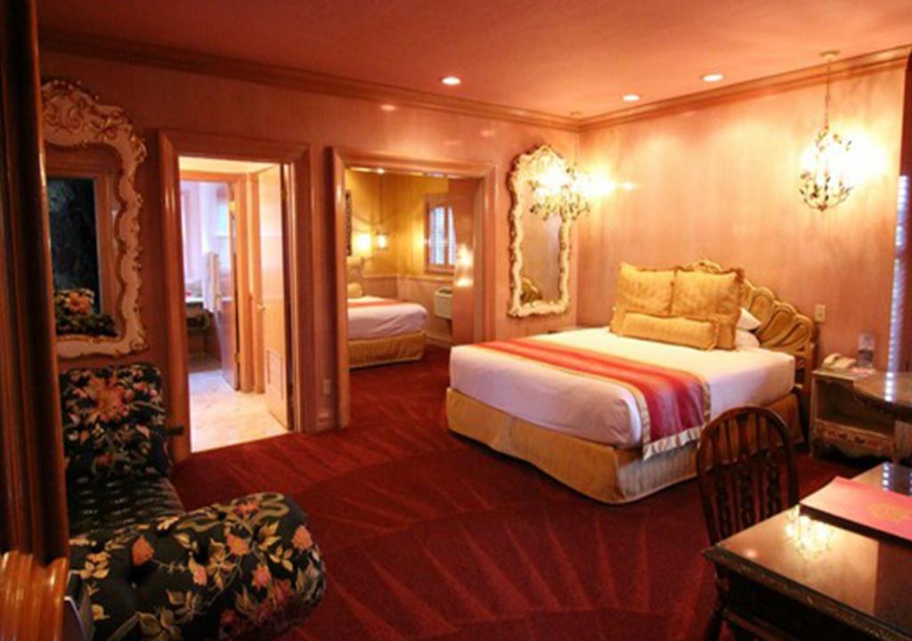 a hotel room with a bed and a chair at Madonna Inn in San Luis Obispo