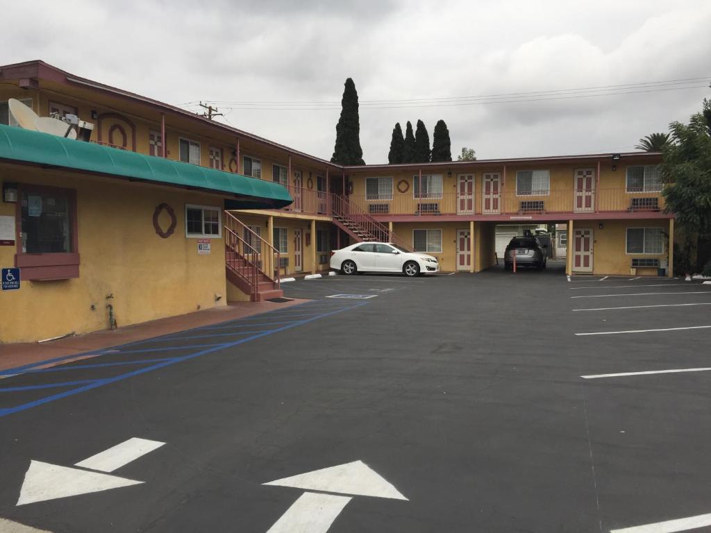 an empty parking lot in front of a motel at Super 7 Motel in Anaheim