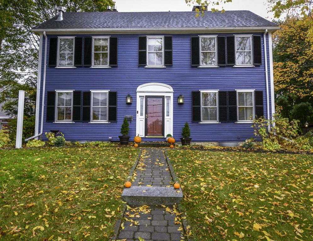 a blue house with a stone walkway in the yard at Elms of Camden in Camden