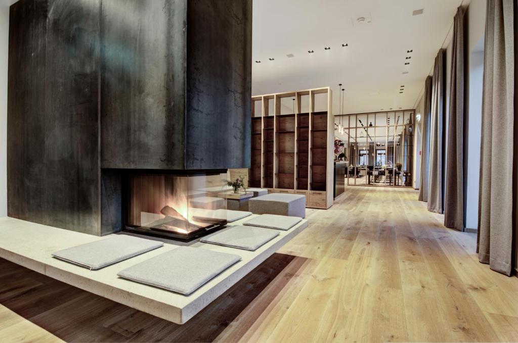a hallway with a fireplace in a building at Seehotel Bellevue in Zell am See