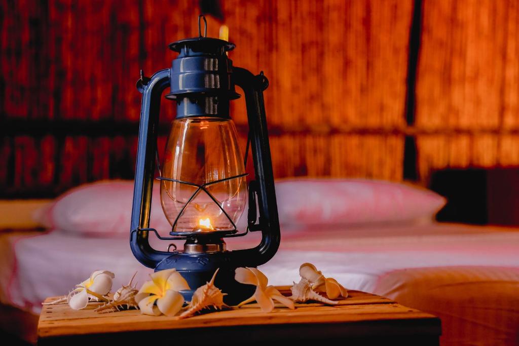 a lantern sitting on a table in a bedroom at Sandy Edge in Kalpitiya