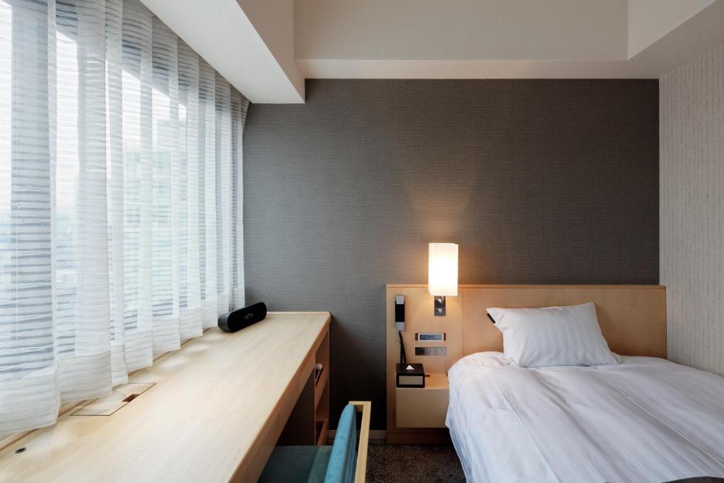 Postel nebo postele na pokoji v ubytování Cocochee Hotel Numazu