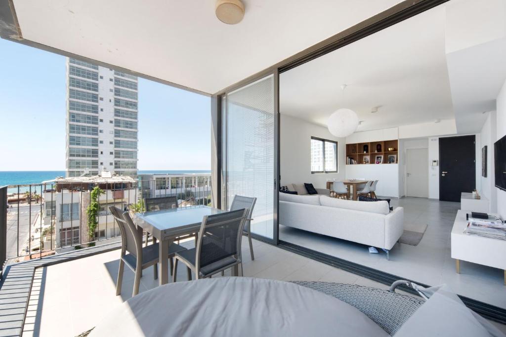a living room with a view of the ocean at Modern 2-BR in Carmel Market by HolyGuest in Tel Aviv