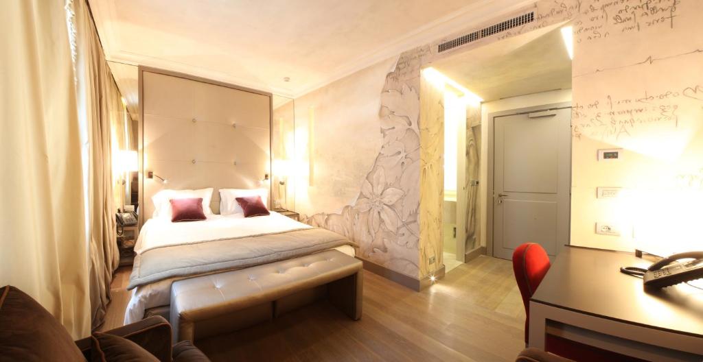 Postel nebo postele na pokoji v ubytování Palazzo Righini