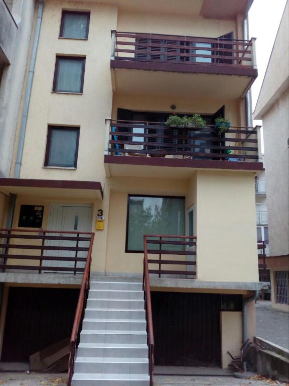 a building with stairs leading up to a balcony at Apartment Viktor stan na dan in Šabac