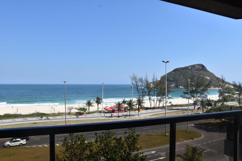 a view of the beach from a balcony at Apartamento completo in Rio de Janeiro