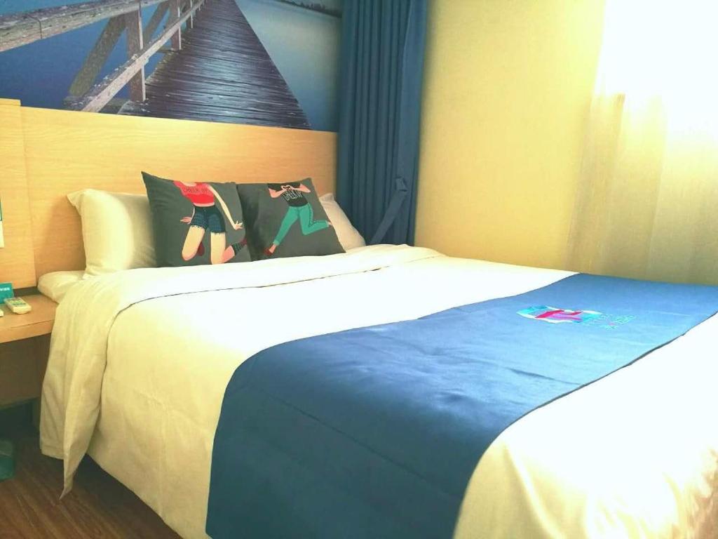 מיטה או מיטות בחדר ב-Pai Hotel Huiam Jinghenggu Plaza