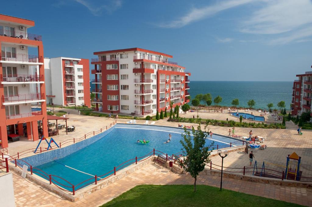 a large swimming pool next to some apartment buildings at Marina and Panorama Apartments in Sveti Vlas