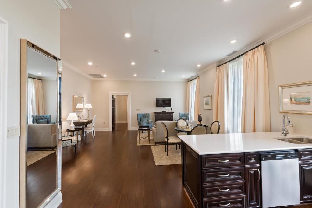 a living room with a kitchen and a dining room at Sydney Boutique Inn & Suites in Charlottetown