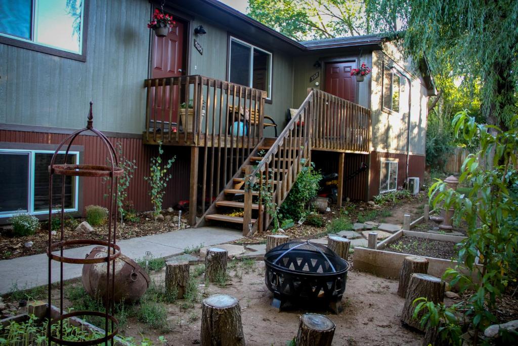 a house with a staircase and a porch with a yard at The 8th Street Retreat in Carbondale