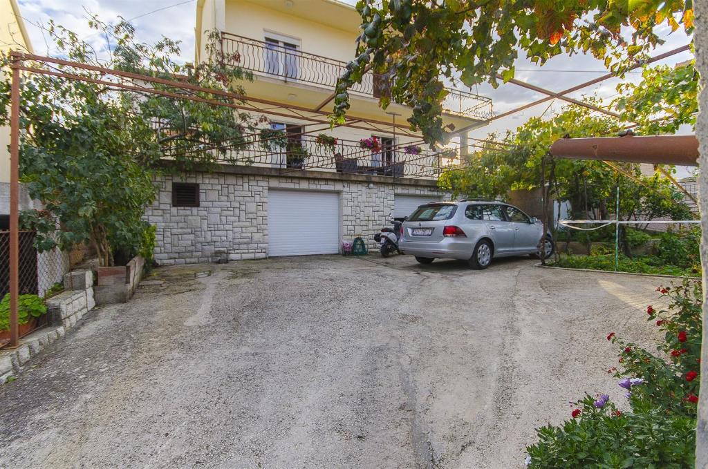 a parking lot with a car parked in front of a building at House Marija in Trogir