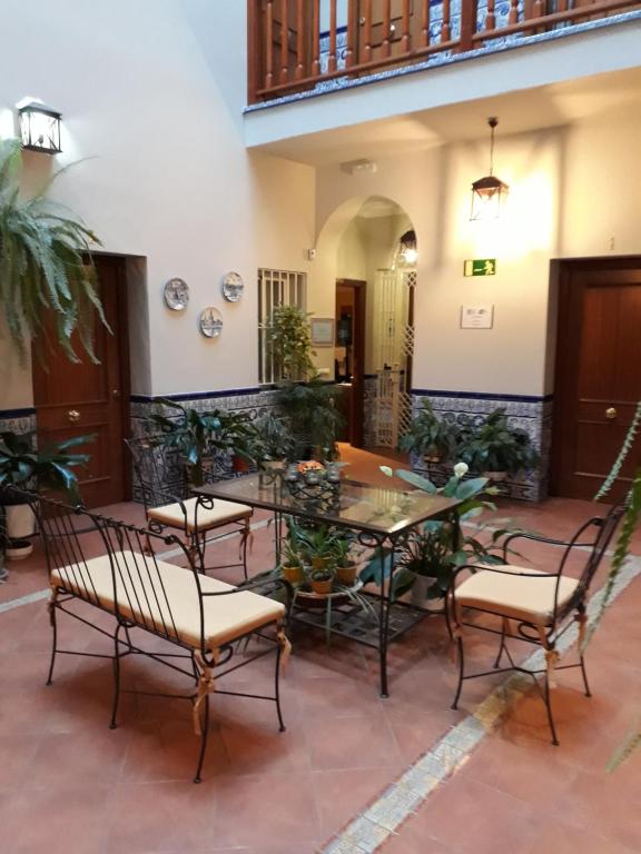 a patio with a table and chairs in a building at Pension Doña Trinidad in Seville